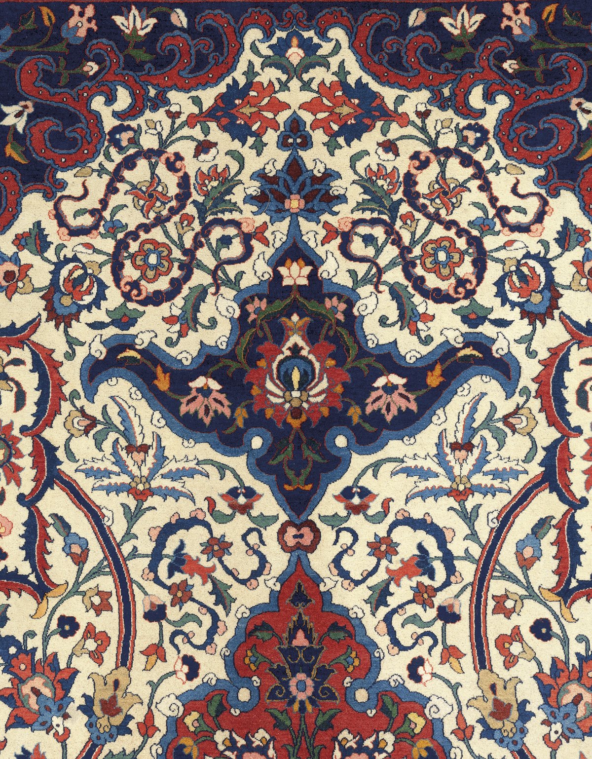 Detail of an ivory-ground Isfahan carpet, circa 1930: dense scrolling vinework and palmettes around a pendant, the drawing carrying the field.