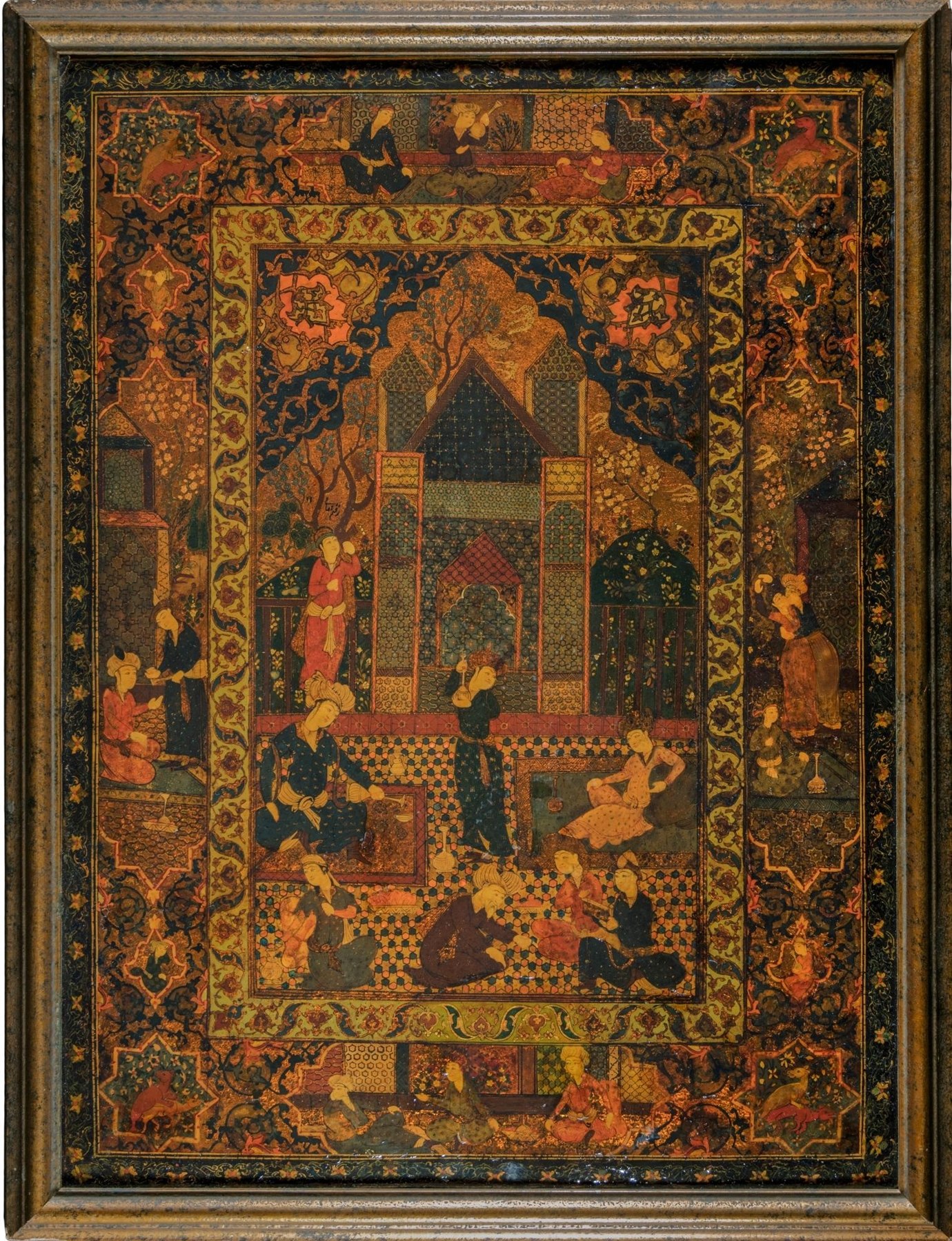 A large lacquer panel by Mirza Agha Emami in its frame: a Safavid garden gathering rendered in burned and painted leather, gold and deep greens.