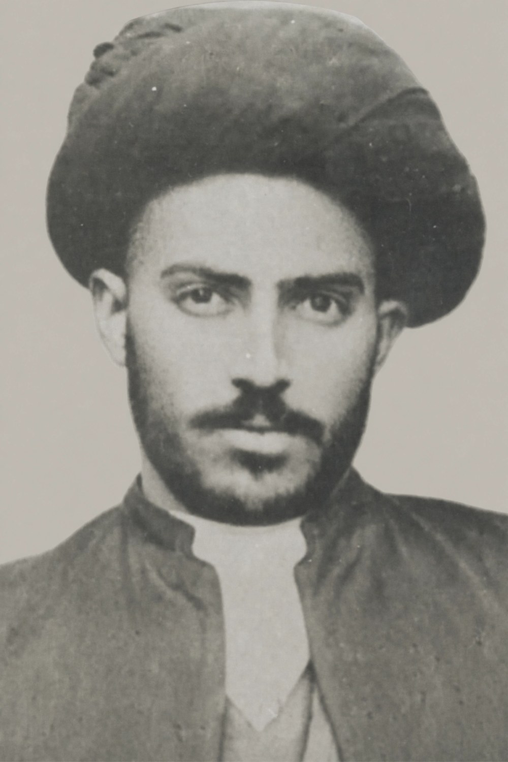 Mirza Agha Emami as a young man: dark-bearded, in the turban of the Emami sadat, photographed around the turn of the century.