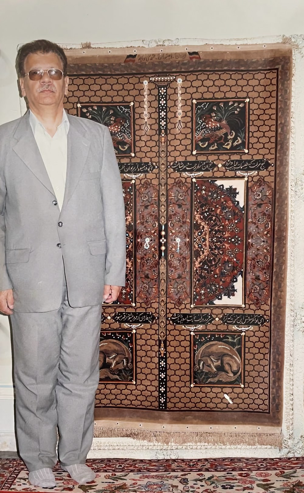 Mohammad Ali Khajeh photographed beside one of his sculpted-relief &lsquo;Door&rsquo; carpets.