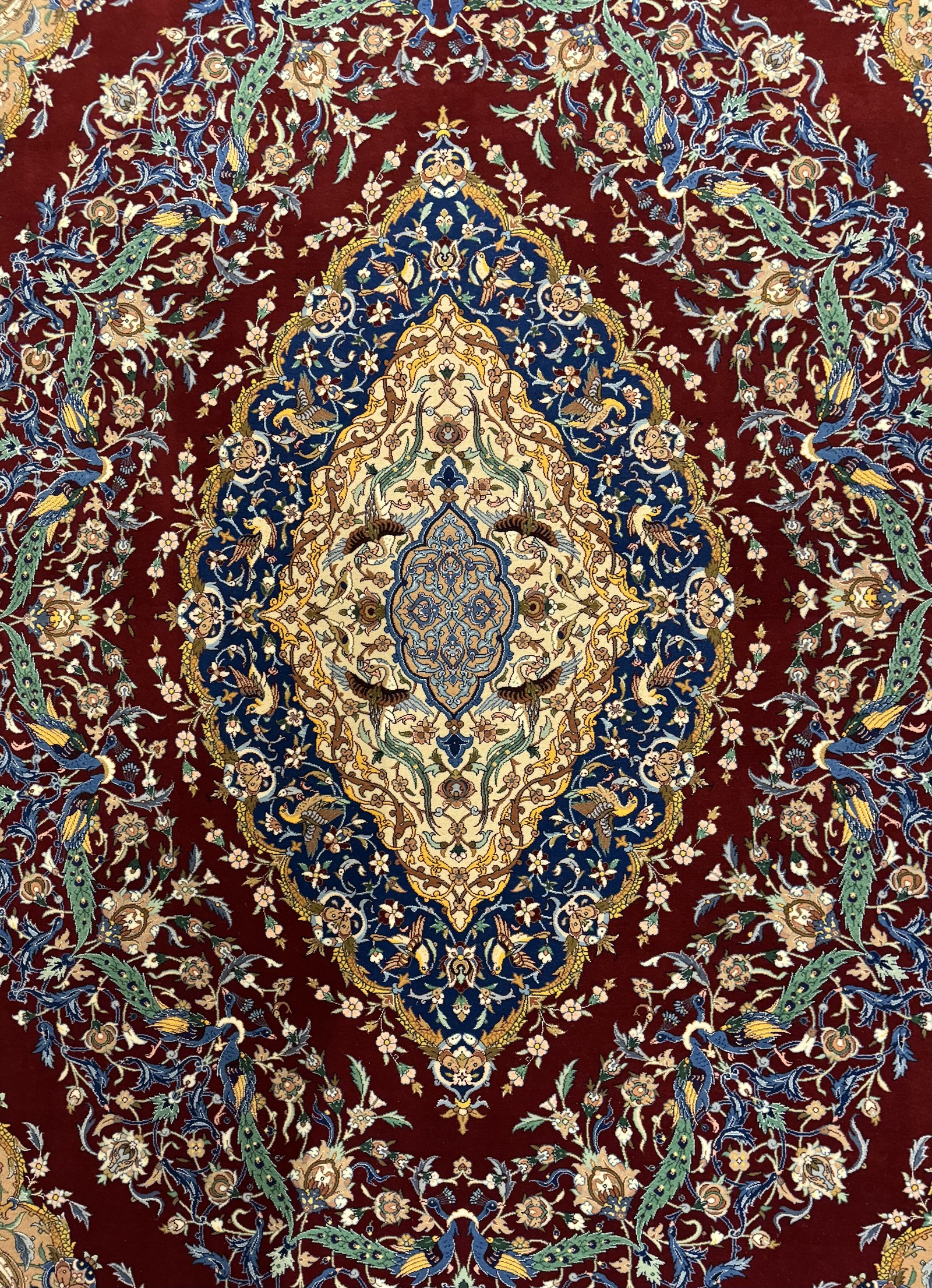 Peacock, a Dadkhah medallion carpet of Isfahan on a red field.