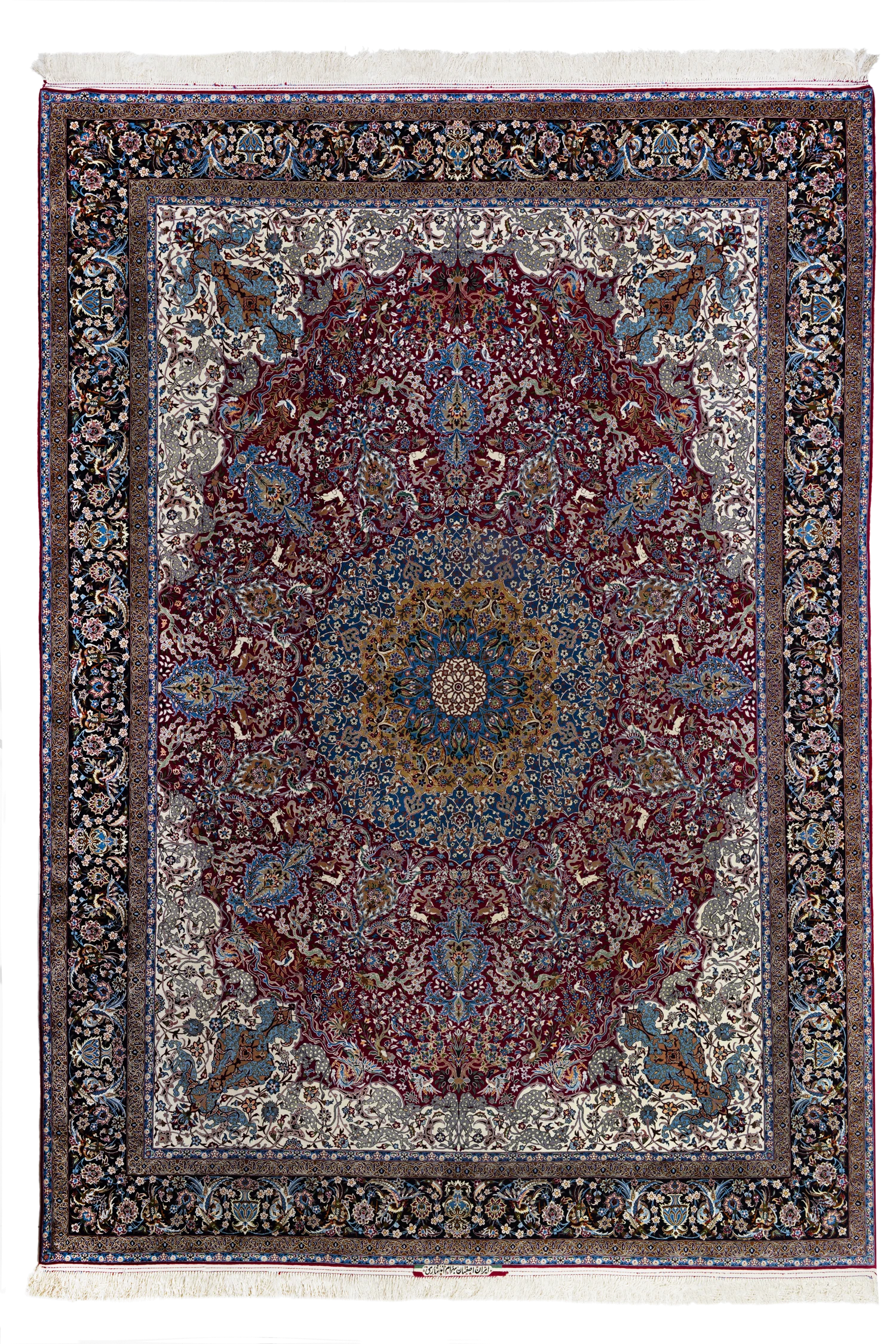 A large star-medallion Isfahan carpet by Ahmad Zojaji: an ivory field of dense Shah Abbasi flora around a red-and-navy star medallion, navy corner medallions, and a deep wine border, the white silk fringes visible at both ends.